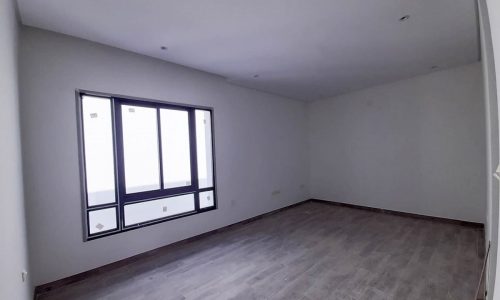 Brand New empty room with wood floors and a window showcasing upscale location.