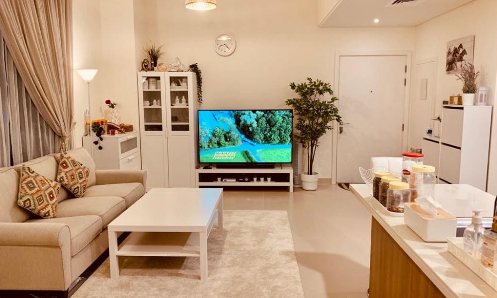 A luxurious living room with a tv and a couch.