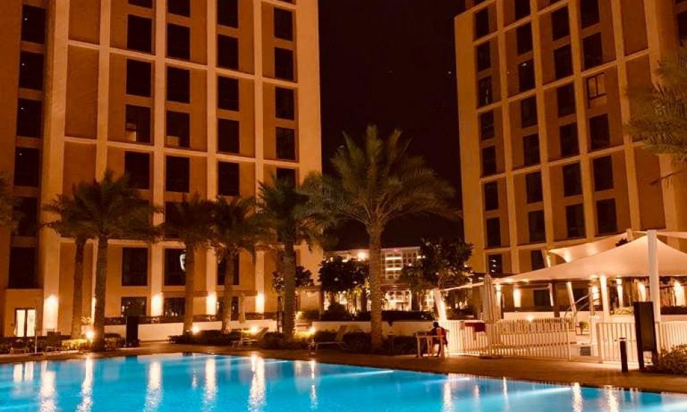 A luxurious hotel swimming pool at night.