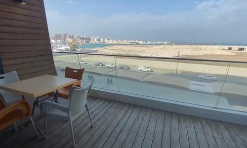 For sale: A sea view apartment on Dilmunia Island with a balcony overlooking the beach and ocean.