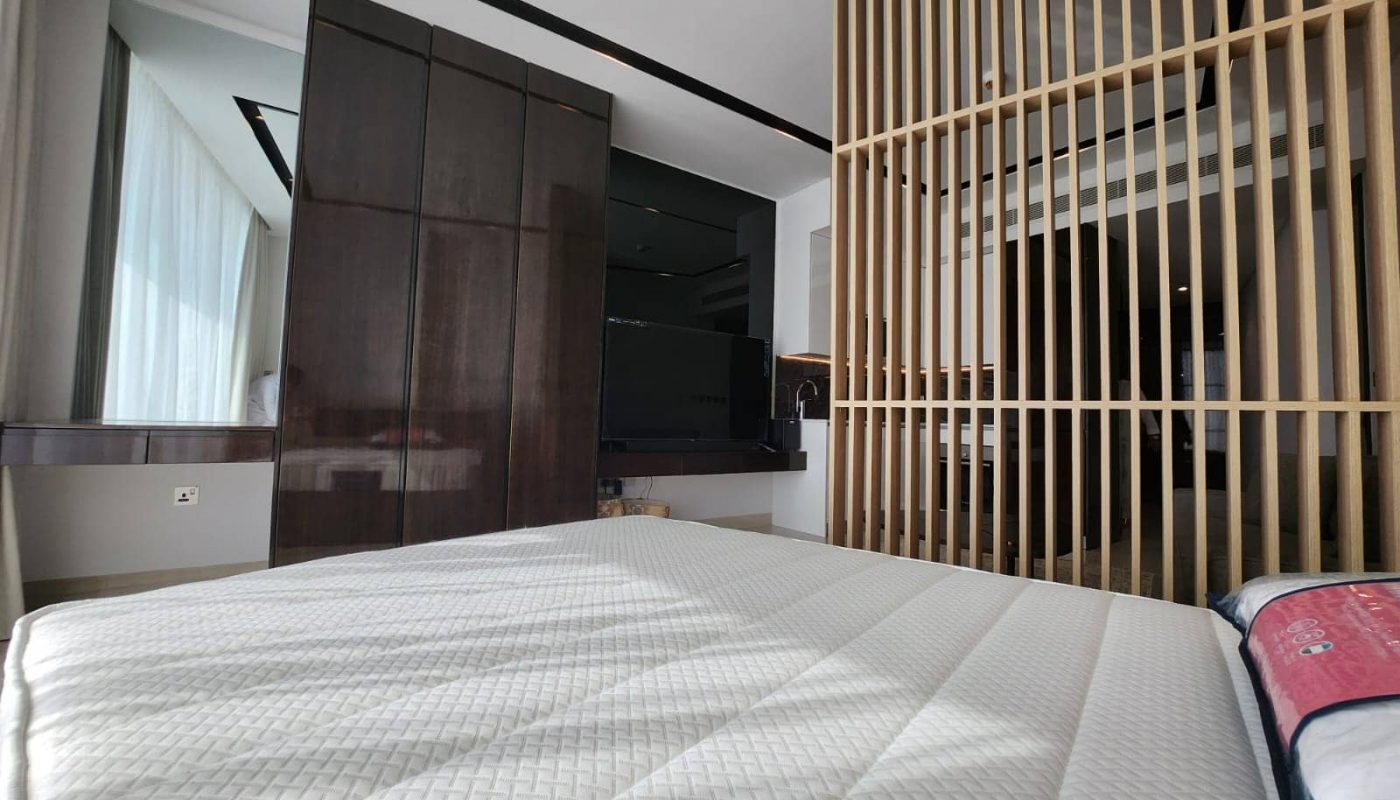 A Studio bedroom in Spiral Orchid Residence with wooden slats and a bed.