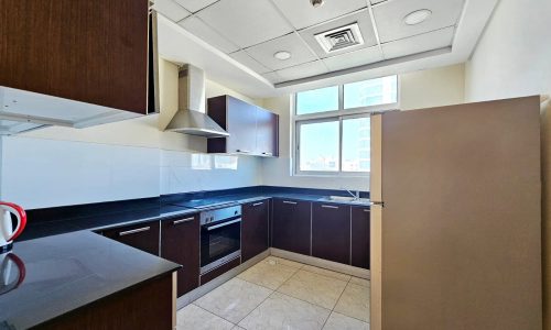 A kitchen with stainless steel appliances and wooden cabinets for a modern aesthetic.