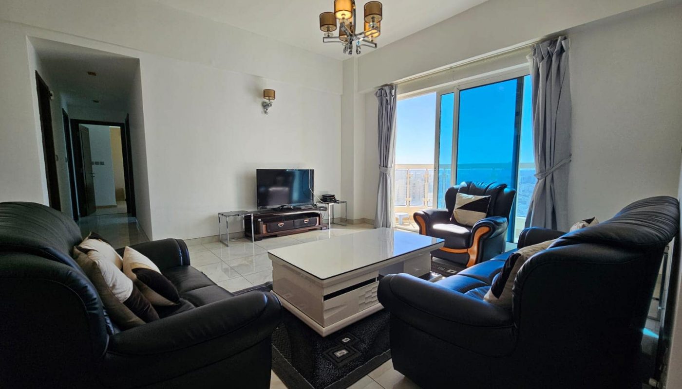 A living room with a television and couches.