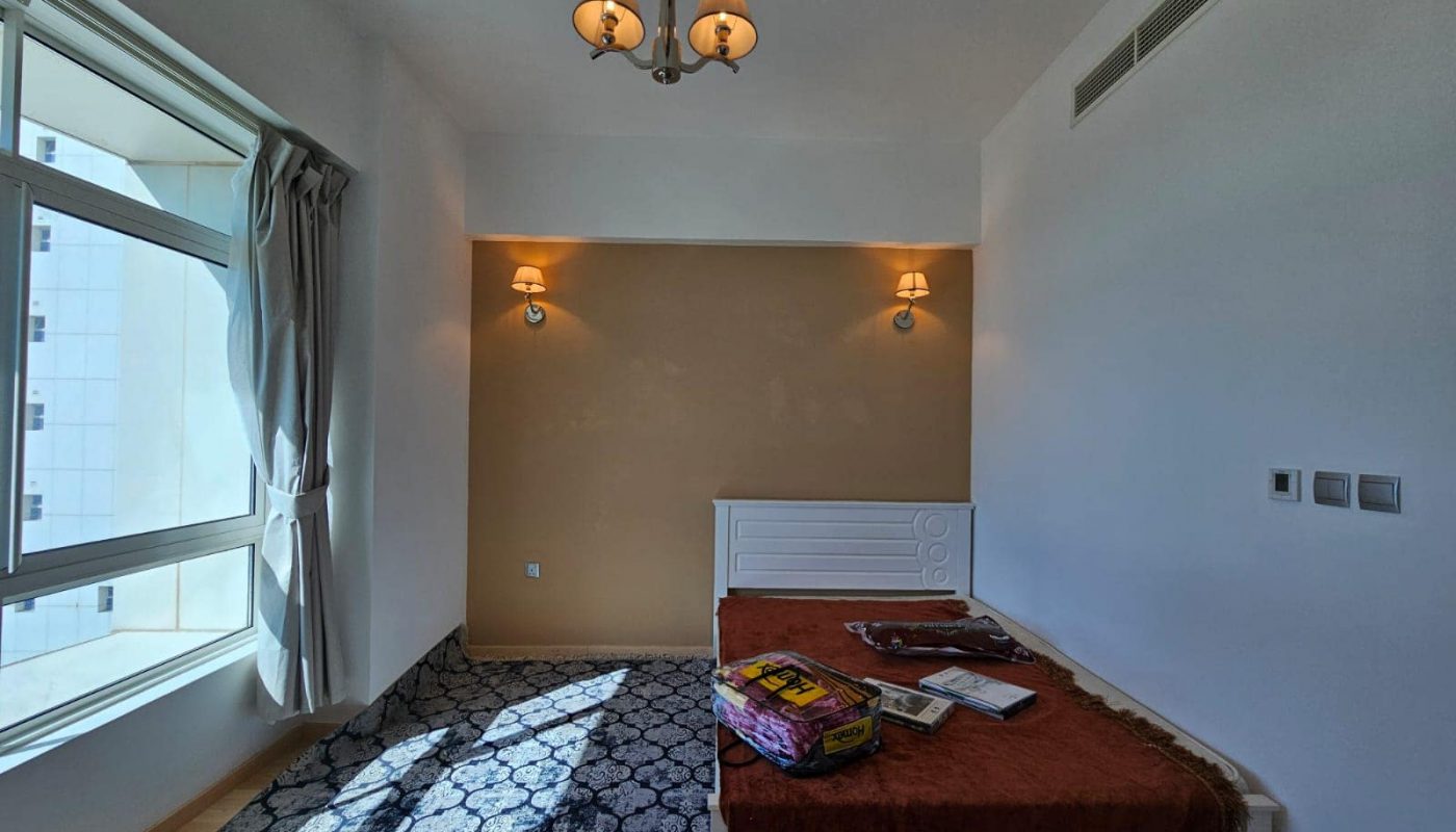 A room with a bed and a window.