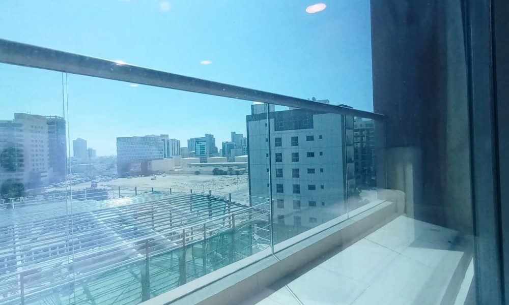 A view of the city from the balcony of an apartment.