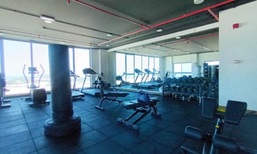 A large gym with a view of the ocean.