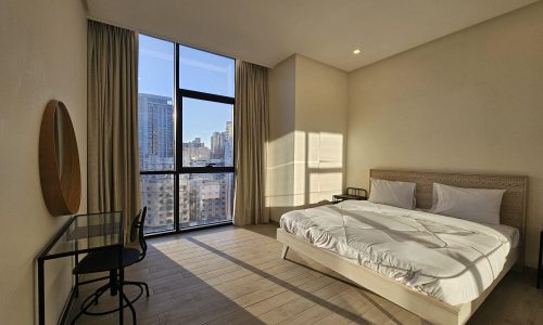 A city view bedroom with a large bed perfect for SEO.