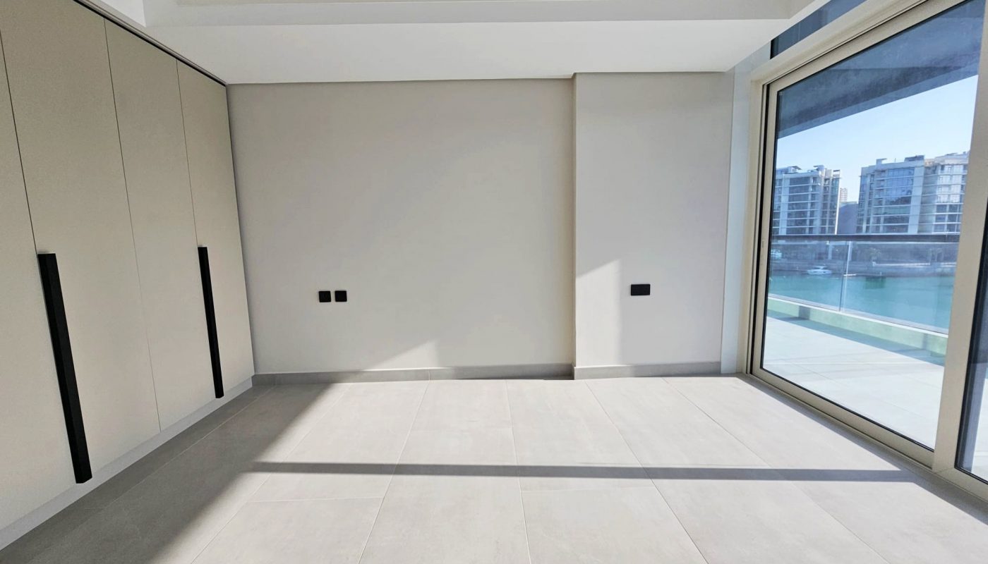 Empty modern apartment room with large windows overlooking a body of water. Auto Draft