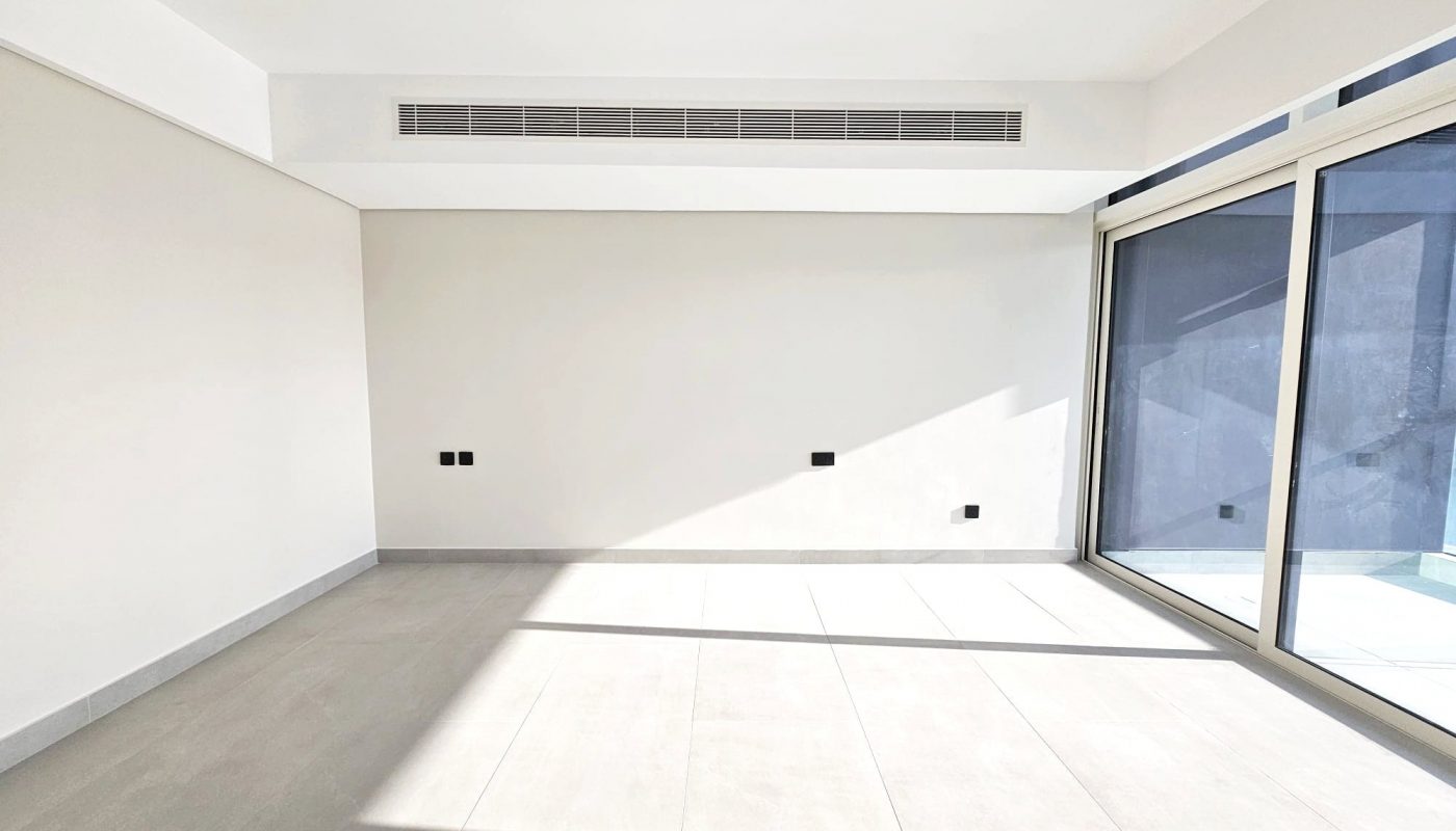 Bright, empty room with large windows, tiled floor, and Auto Draft system.