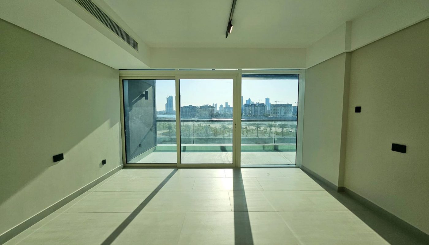 Auto Draft: Empty modern room with large windows overlooking a cityscape.