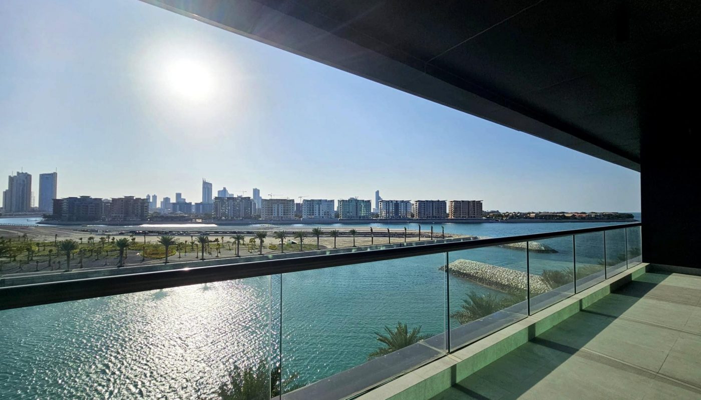 City skyline viewed from a balcony over a calm body of water on a sunny day. Auto Draft