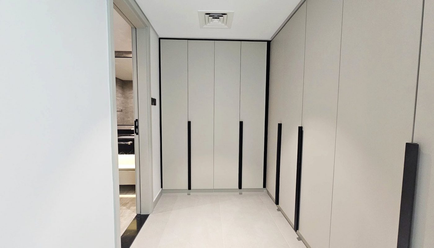A modern corridor with white walls and Auto Draft sliding doors.