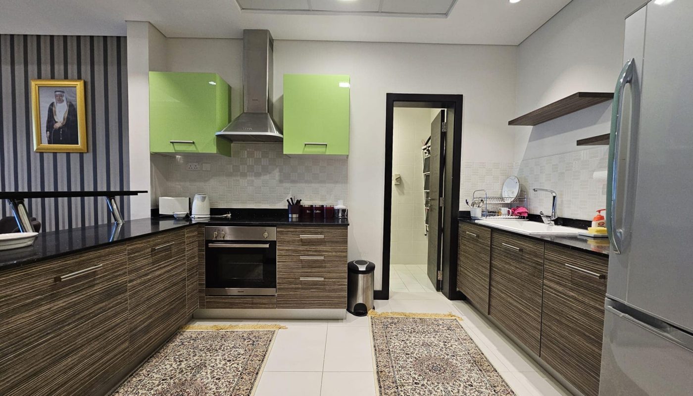 Modern kitchen interior with wooden cabinetry and Auto Draft green accent walls.