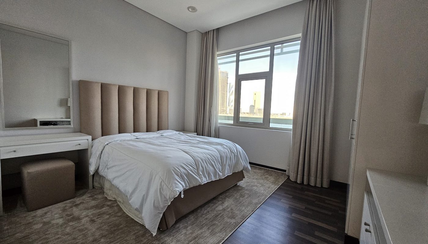 Modern bedroom with a neatly made bed, large window, and minimalistic furniture. Auto Draft