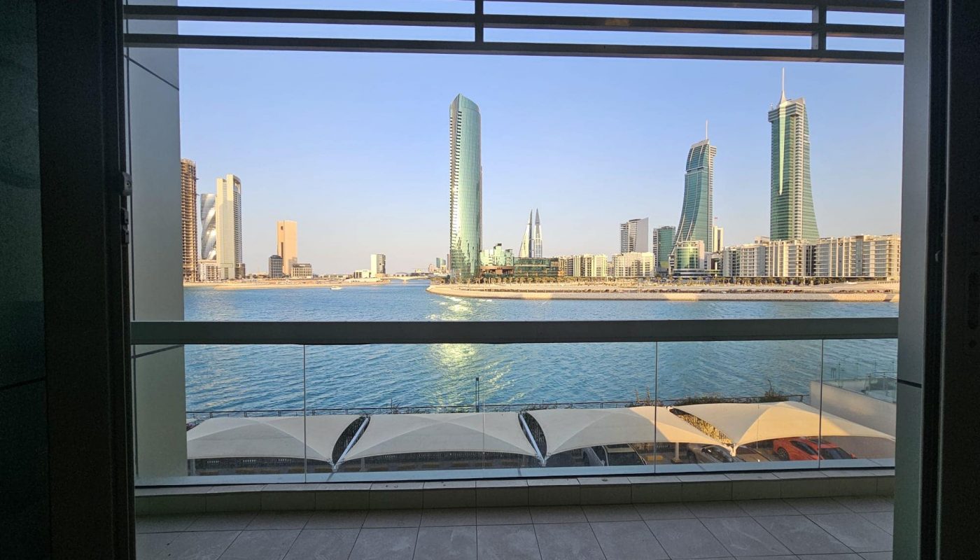 View of a modern city skyline seen from an Auto Draft with waterfront in the foreground.