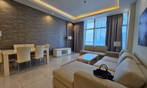 Luxury apartment for rent with a modern living room, beige furniture, and accent lighting in Juffair.