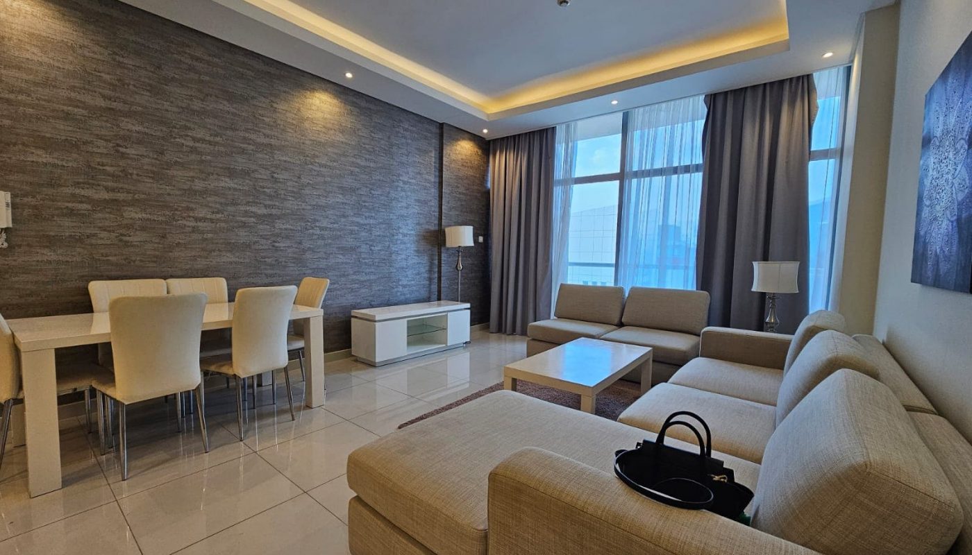 Luxury apartment for rent with a modern living room, beige furniture, and accent lighting in Juffair.