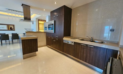 Modern kitchen interior with built-in appliances and a central island.