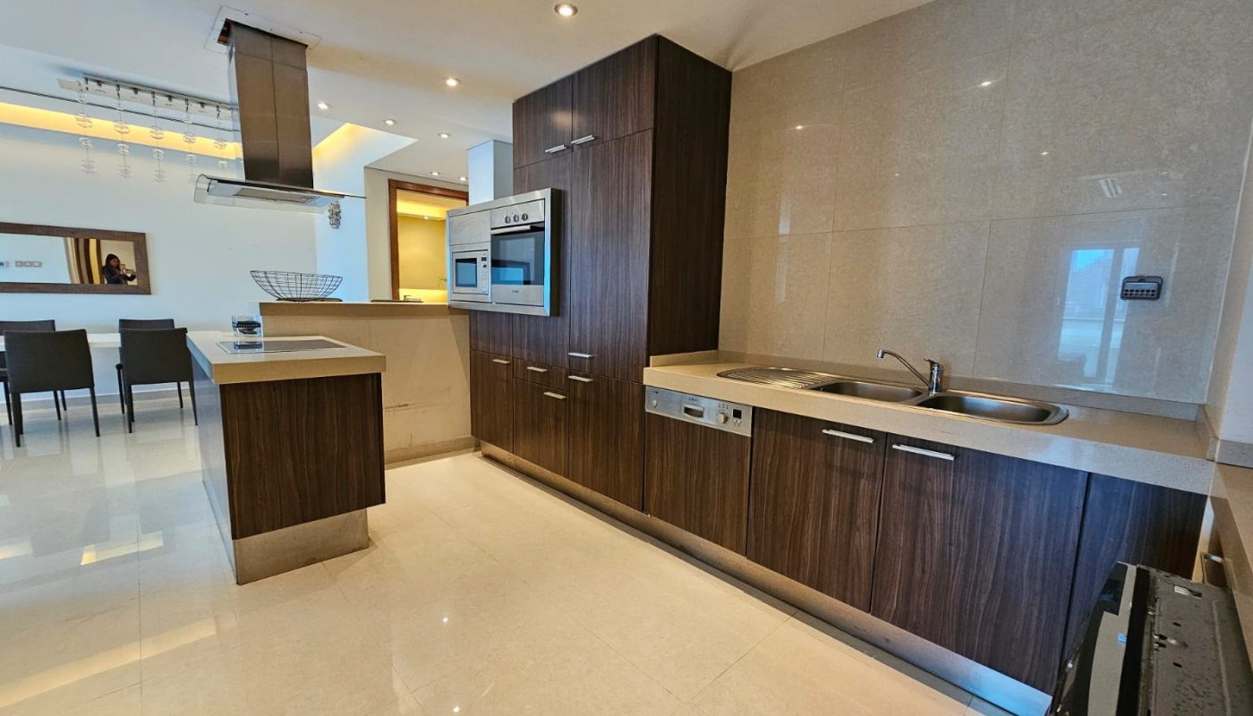 Modern kitchen interior with built-in appliances and a central island.