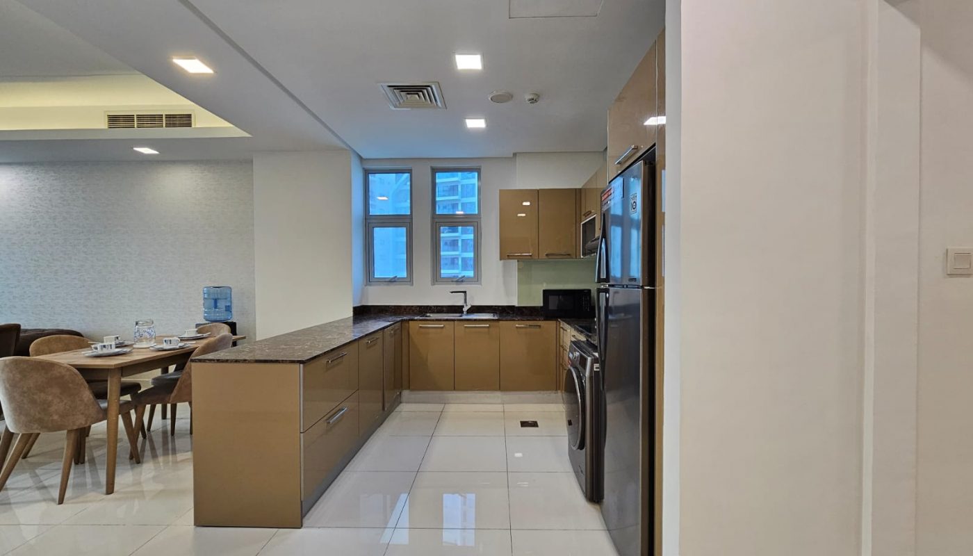 Modern kitchen with wooden cabinets, stainless steel appliances, and an adjoining dining area - Auto Draft.