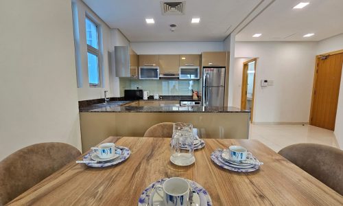 Modern kitchen interior with a dining table set for four and an Auto Draft system.