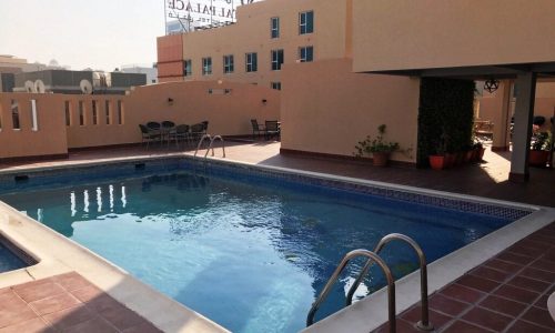 A swimming pool in the middle of an apartment building.