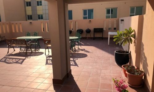 A dream home patio with tables and chairs.