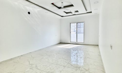 A luxury apartment with a tile floor and a window.