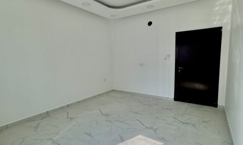 A luxurious apartment for sale in the Al Bahair area. The apartment features an empty room with white walls and a ceiling fan.