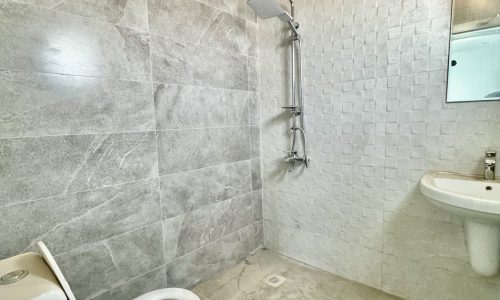 A luxurious apartment with a toilet, sink and shower for sale in Al Bahair.