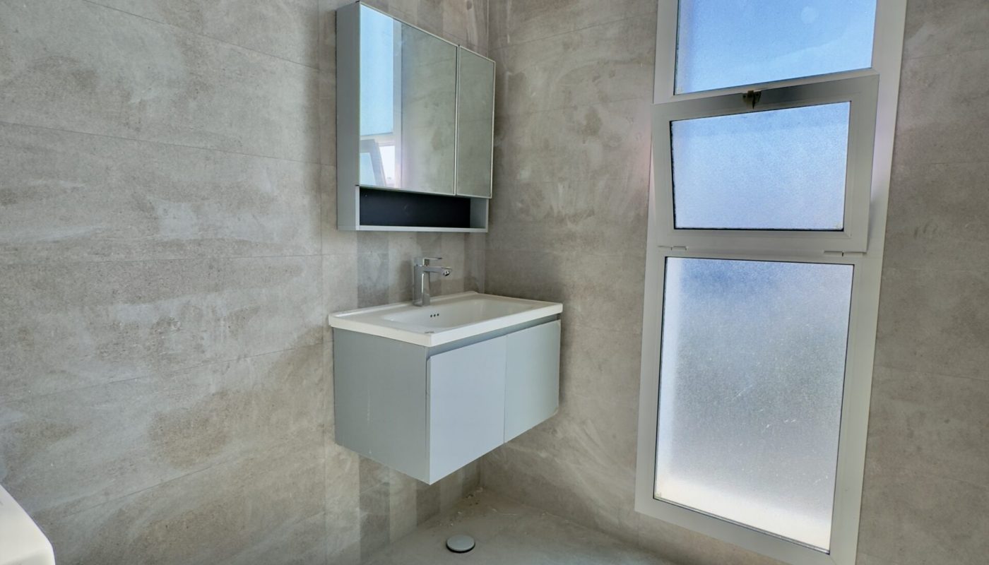 A luxury bathroom with a sink and window.