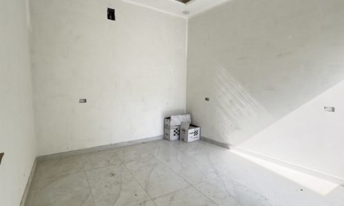 An elegant room with white walls and tile floors.