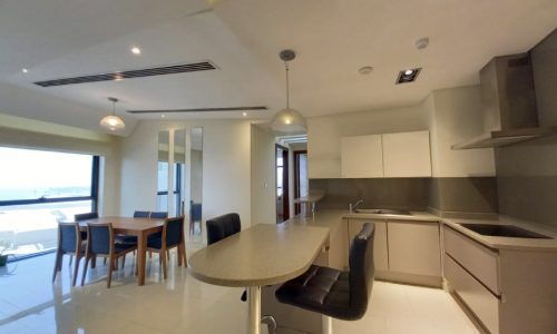 A luxury modern apartment with a kitchen and dining area, featuring a balcony.