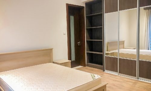 Modern 2BR flat with a bed, dresser, and mirror for rent in Saar.