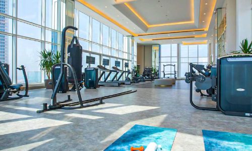 A spectacular gym room with a view of the city in a Seef flat.