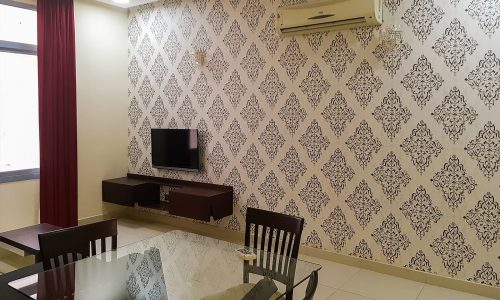 2BR furnished apartment in Adliya with living room, dining area, and flat screen TV.