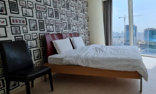 A modern bedroom with a city view.