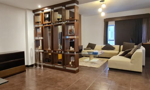 Exquisite living room in a 2BR apartment for rent in Juffair with furniture and a coffee table.