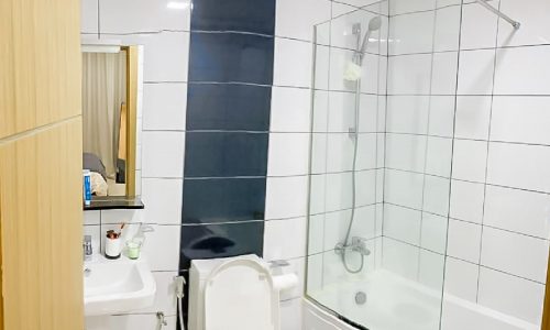 Luxury 2BR apartment for sale in Seef Area, featuring a bathroom with toilet, sink, and shower.