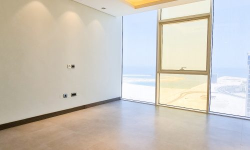 A luxury flat with large windows overlooking the ocean, available for sale in Seef.