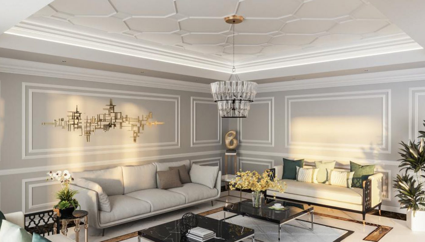 Modern living room with two sofas, decorative wall molding, a geometric chandelier, glass tables, plants, and neutral tones accented by natural light.