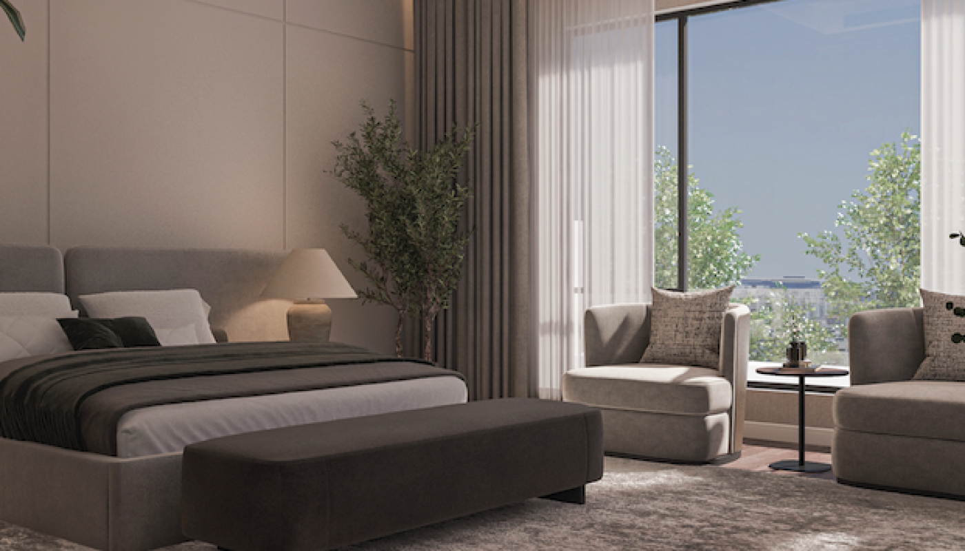 Modern bedroom with a large bed, ottoman, two armchairs by a window, neutral-tone decor, a floor lamp, indoor plant, and natural light streaming in.