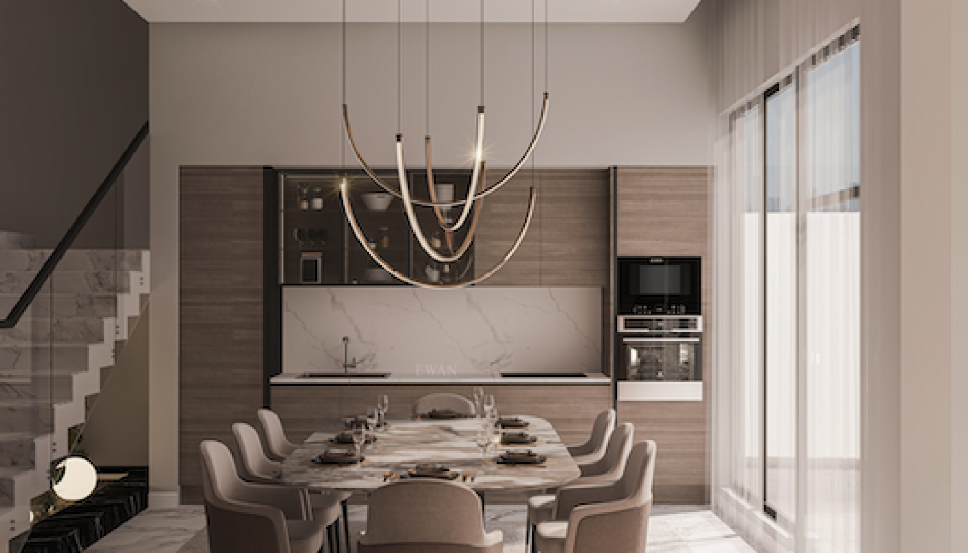 Modern dining room with a long marble table, twelve chairs, large chandelier, and an open kitchen featuring wood cabinetry and built-in appliances. Natural light comes through tall windows.