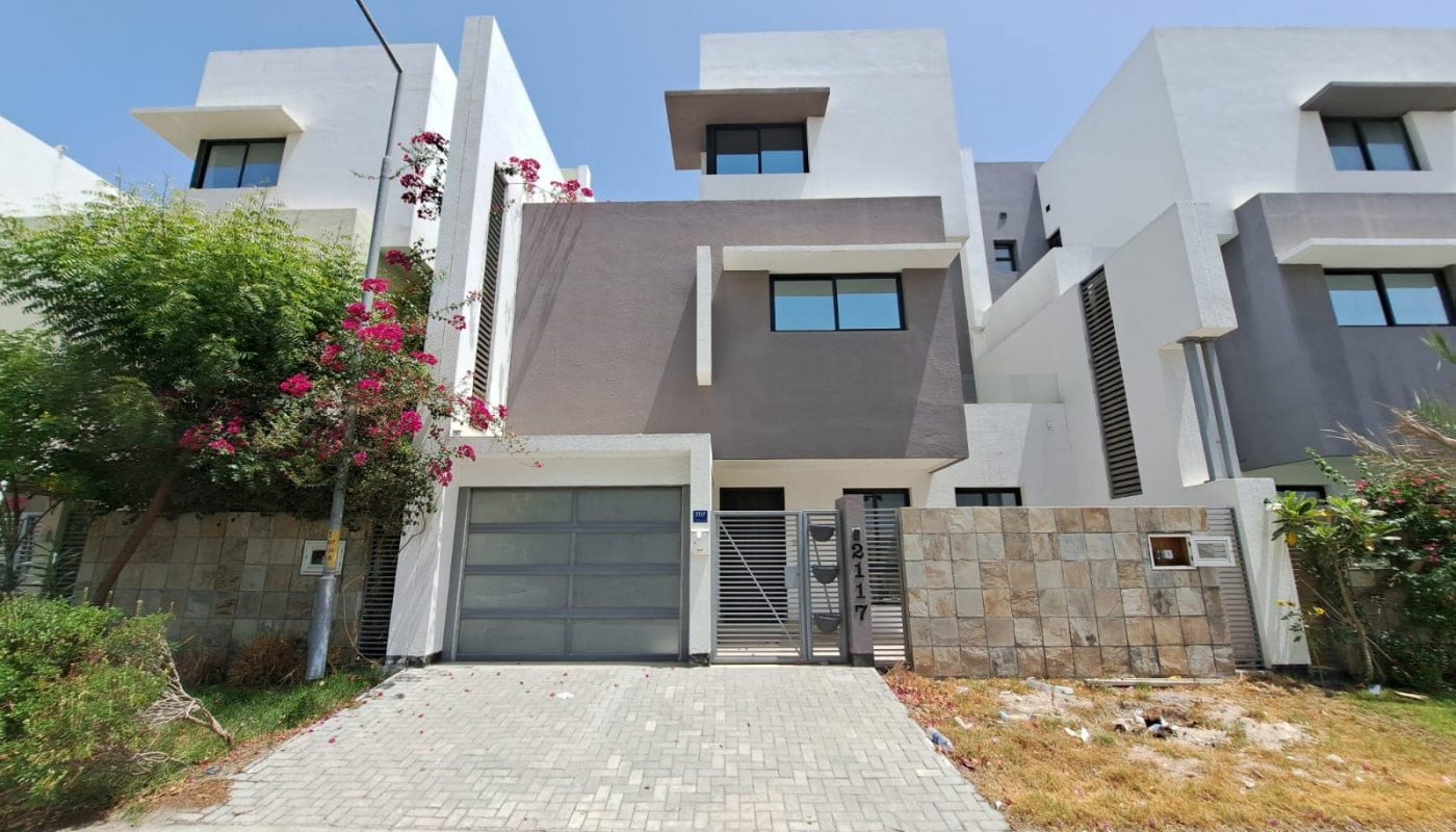 For sale, a luxury villa with exceptional design featuring two garages and a driveway.