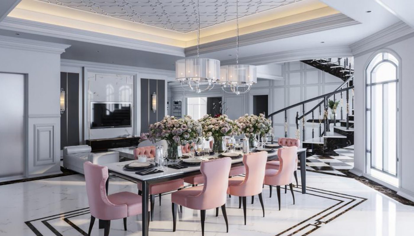 Elegant dining room with a long table, pink chairs, floral centerpieces, modern chandeliers, large windows, and a spiral staircase in a bright, spacious interior.