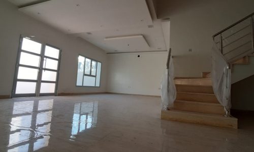 Fascinating 5BR Villa with a large living room and stairs, featuring a white floor, for sale in Bani Jamra.