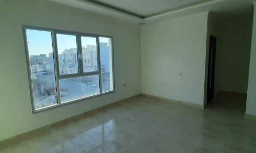 A 5BR Villa for Sale in Bani Jamra with a fascinating view of the city through large windows.