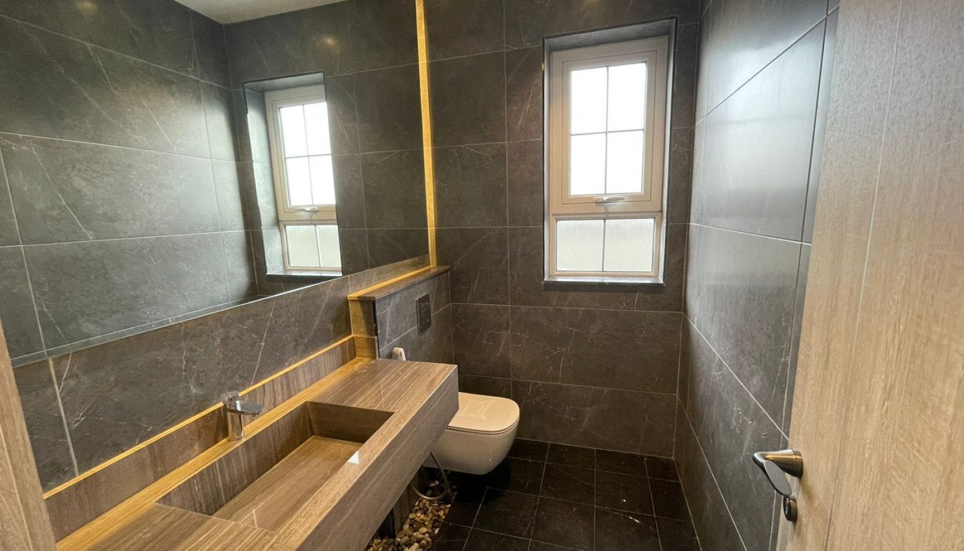 A modern bathroom with a sink and mirror in a Luxury Villa.