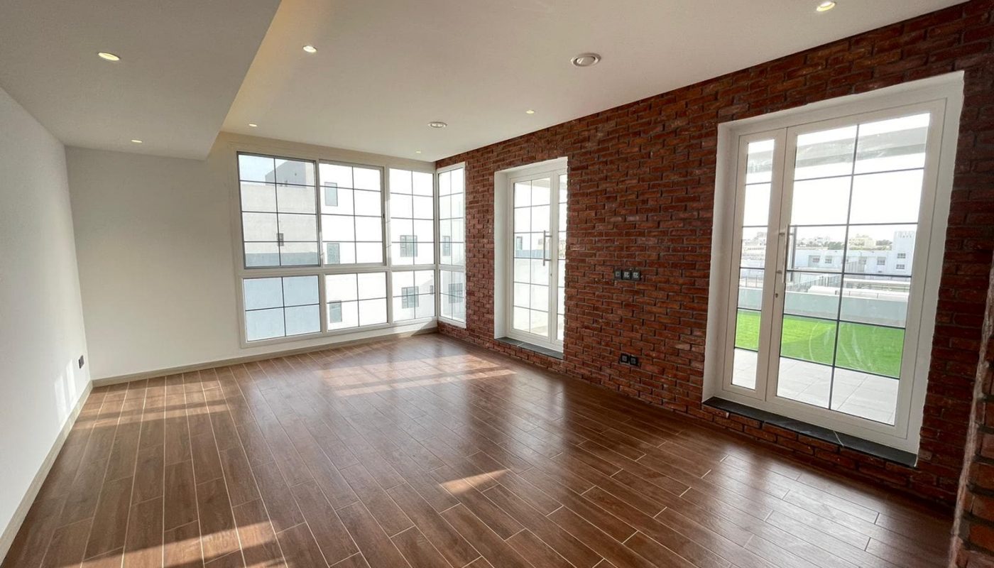 A luxurious villa with five bedrooms, featuring brick walls and wooden floors.