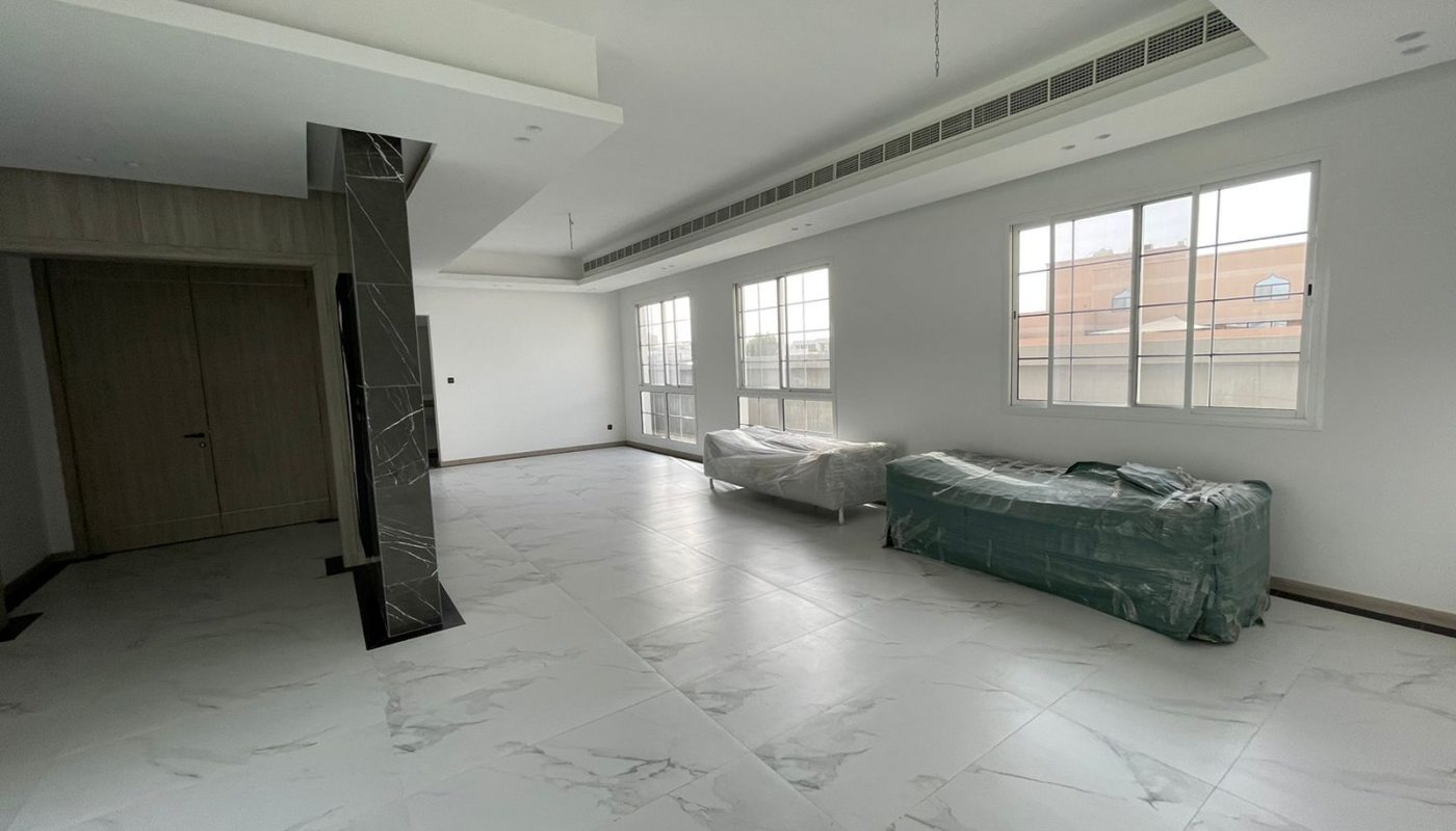 A luxury living room with a white tile floor and a window.